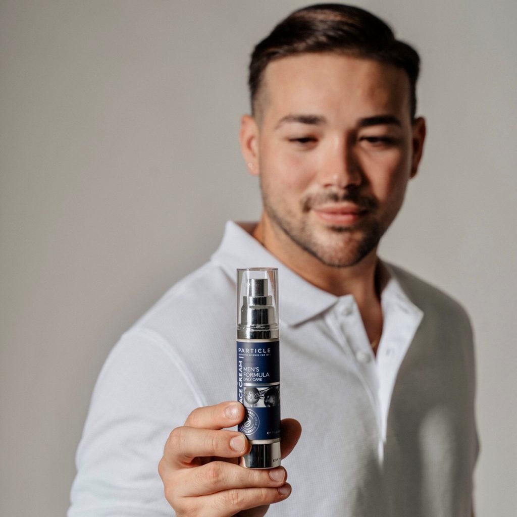 Man holding Particle Face Cream bottle