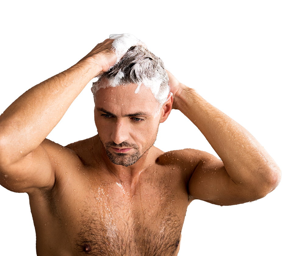 Man washing hair with lather in shower.