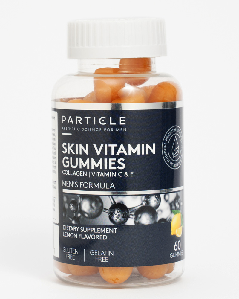 Particle Skin Vitamin Gummies bottle with blue label and scattered gummies