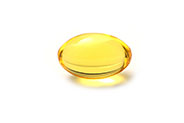 Yellow oil capsule pill on a plain white background.