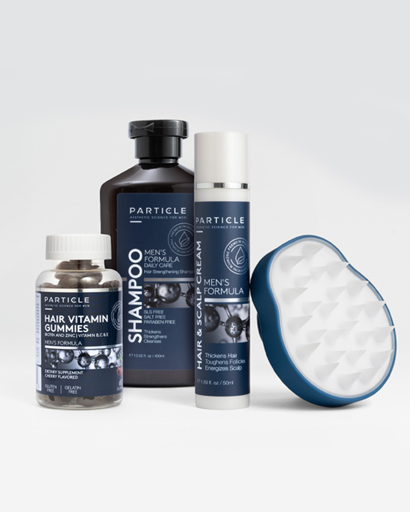 Particle hair care products for men including hair vitamin gummies, shampoo, hair and scalp cream, and a scalp massager, arranged side by side